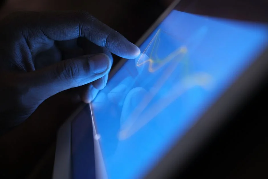 Close-up view of hands using a shopping website displayed on a laptop screen indoors.